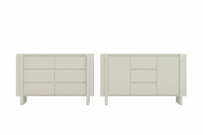 Two white dressers in a room with a window and decor.