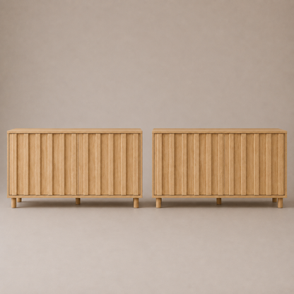 Two matching light oak sideboards with vertical slat detailing and short legs, shown side-by-side against a neutral beige background.