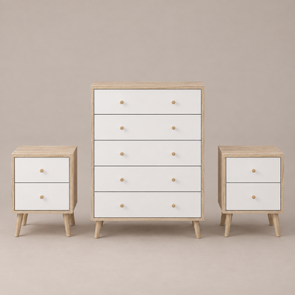 A three-piece bedroom furniture set including a five-drawer chest, a two-drawer nightstand, and a matching side table, all featuring white drawer fronts, light natural wood tops and legs, and round wooden knobs, set against a solid warm gray background.